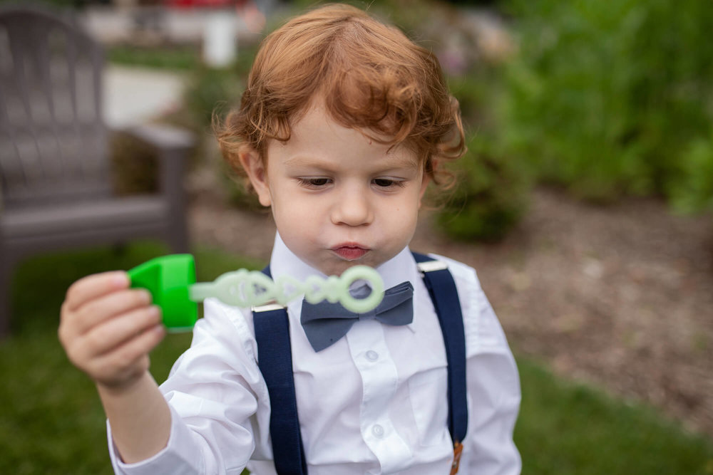 Rustic Wedding in South New Jersey | Little Boy playing with bubbles
