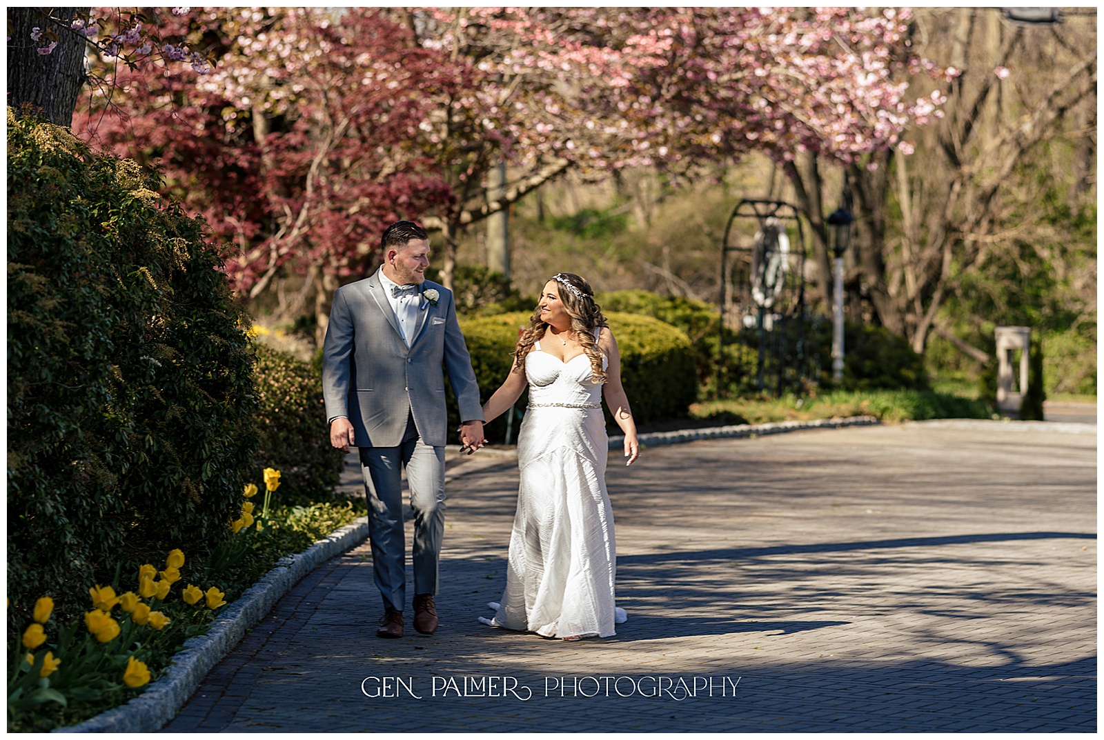 Spring Estate at Eagle Lake Wedding Couple Walking with Cherry Blossoms