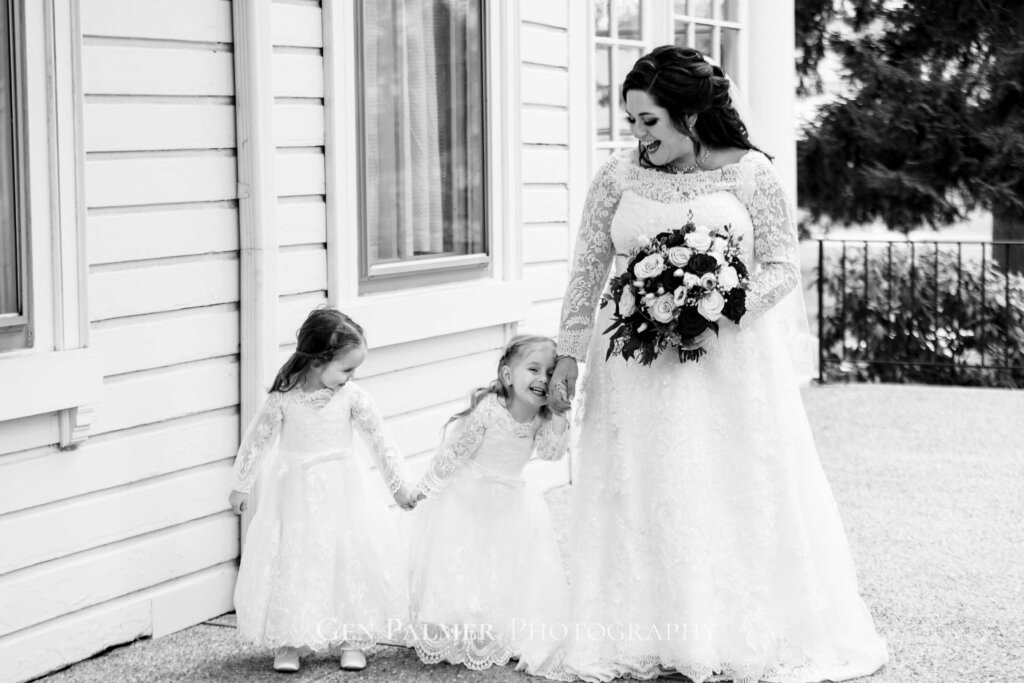Bride having a fun moment with the flower girls