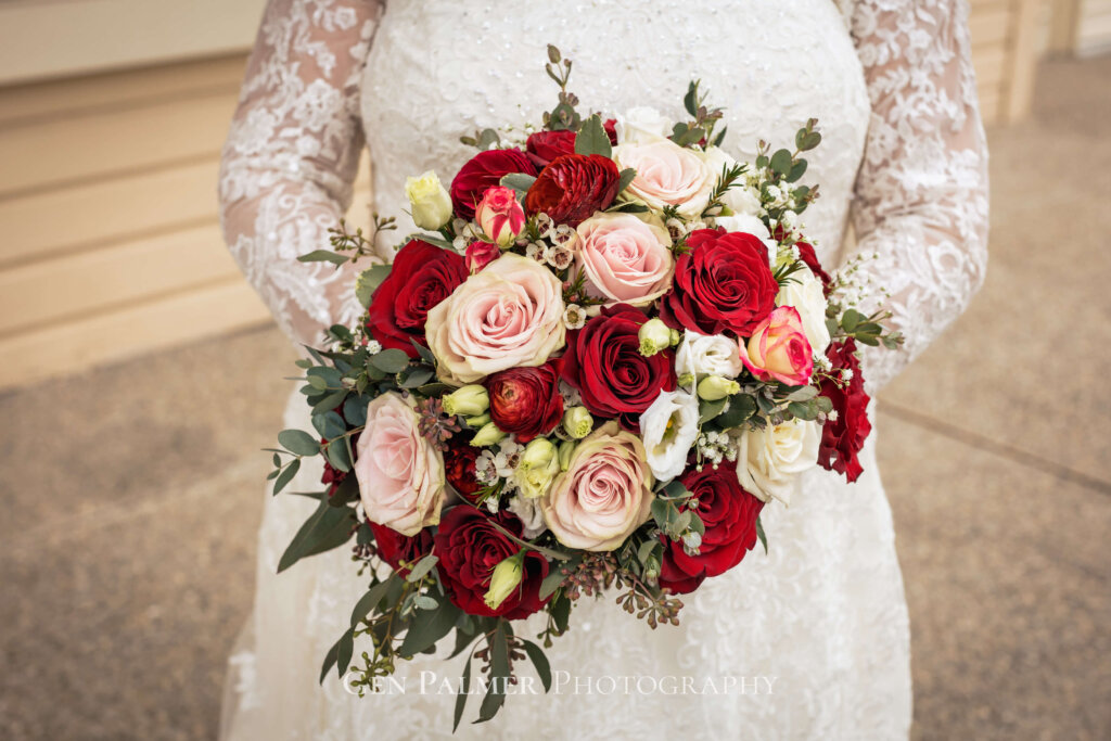 Bride's bouquet of red and pinkish flowers