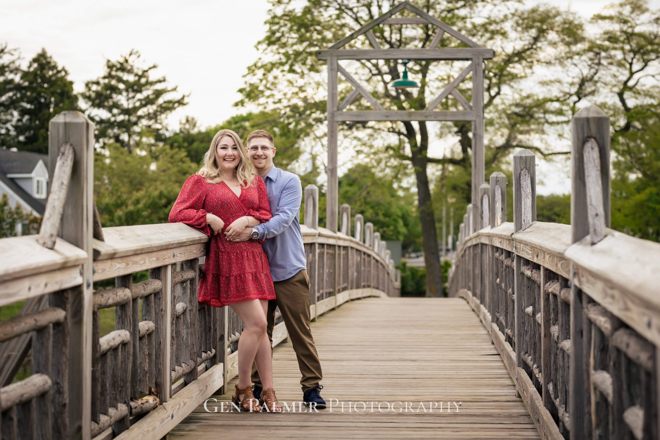 Couple hugging by the bridge