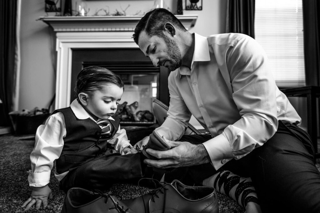 How to Choose a Wedding Photographer | Documentary wedding photography of a groom dressing his son on his wedding morning