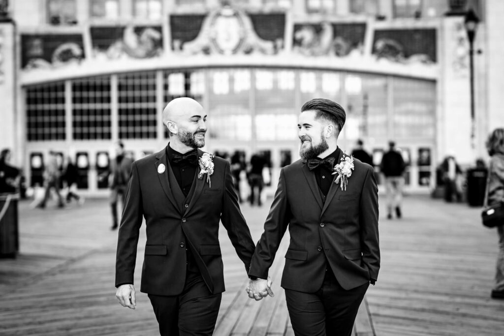 LGBTQ+ Wedding Couple hand-in-hand at Asbury Park Boardwalk
