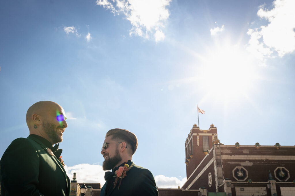 LGBTQ+ Wedding Couple standing in front of building in Asbury Park