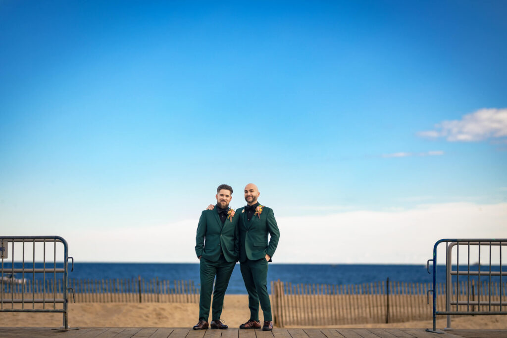 Wedding couple standing in front of beach at Asbury Park