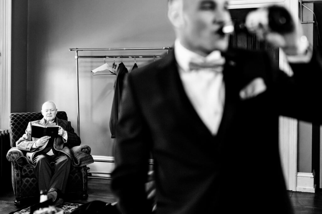 Groom and groom's parent relaxing in room