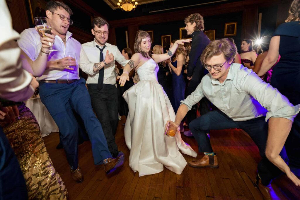 Bride and wedding guests dancing