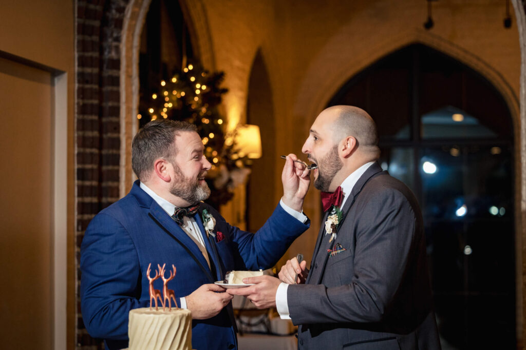 Groom feeding cake to husband at Aldie Mansion