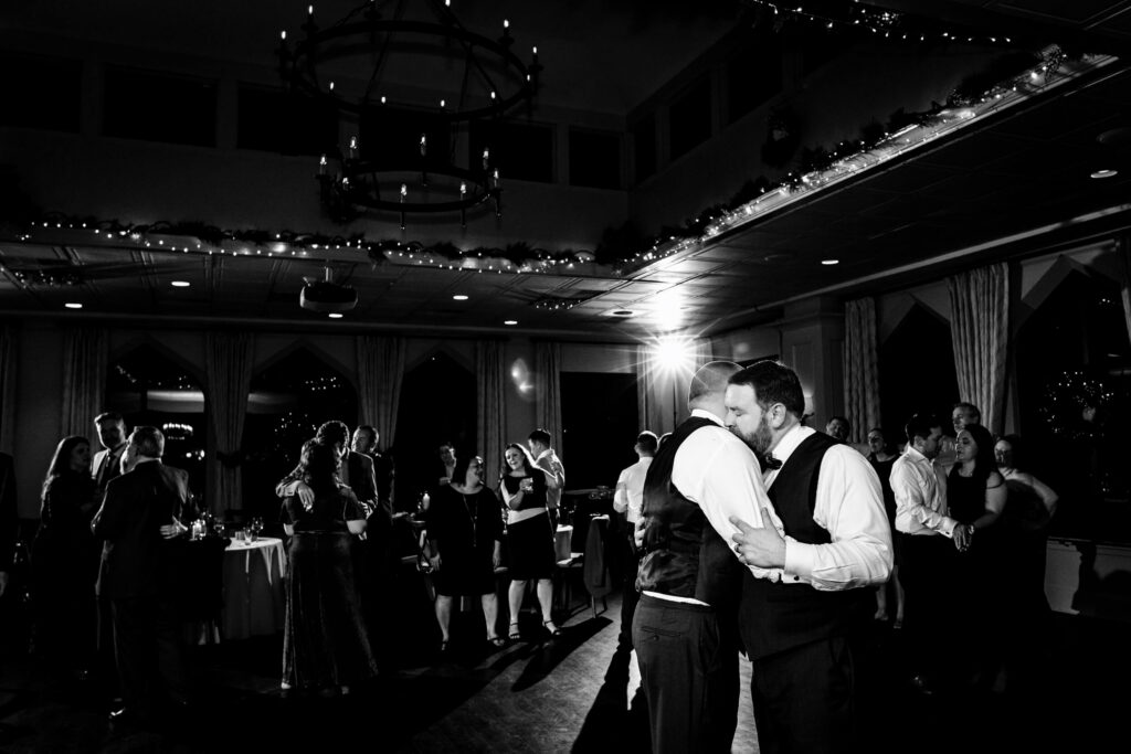 Grooms embracing at Aldie Mansion