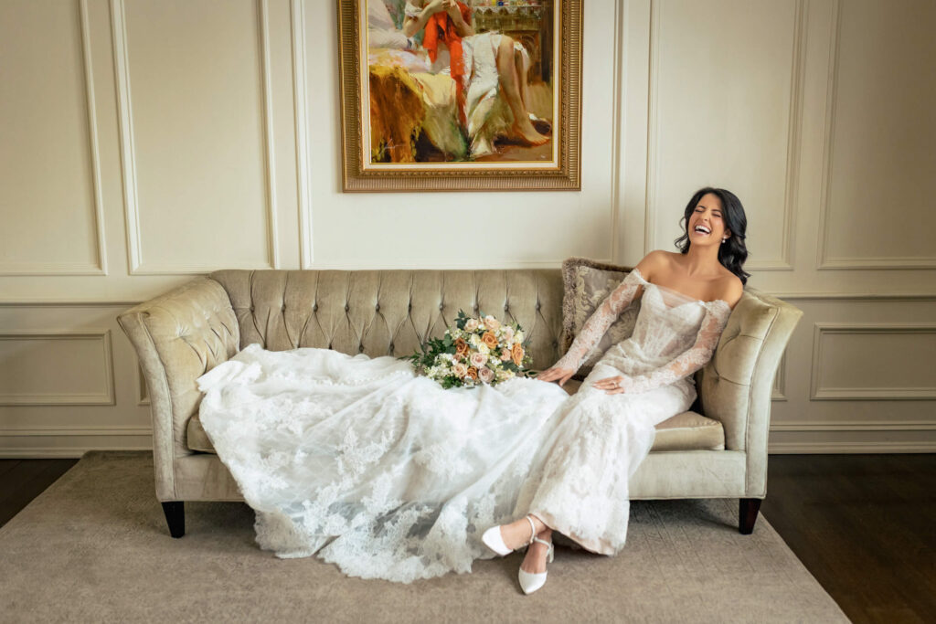 Bride laughing on couch at Nanina's In The Park