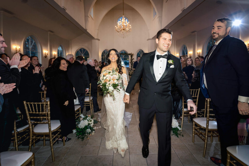 Couple walking down aisle at Nanina's In The Park