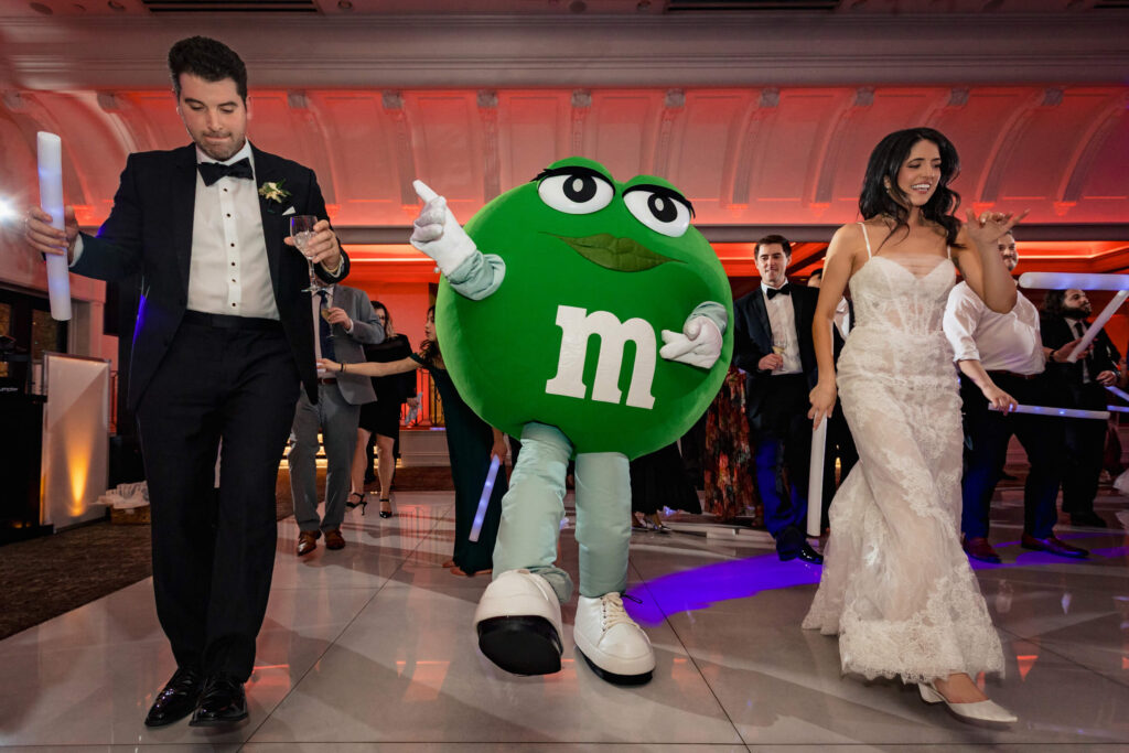 Couple dancing with Green M&M at Nanina's In The Park
